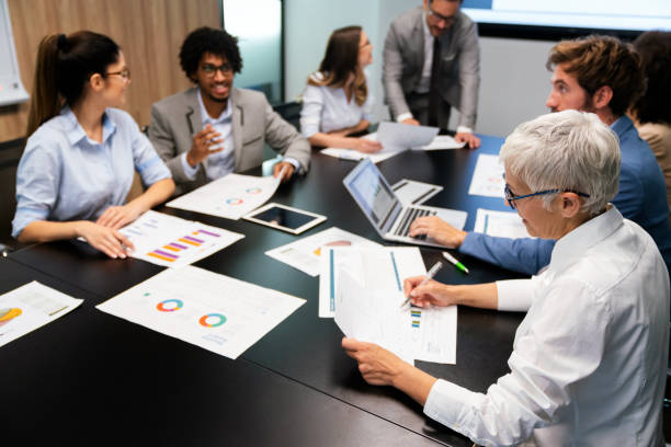 istock Group of business partners discussing documents and ideas at meeting 1323329718