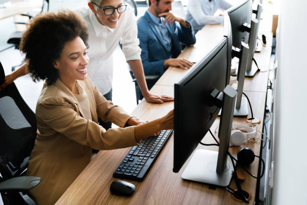 istock Happy business people having fun and chatting at workplace office 1323330291
