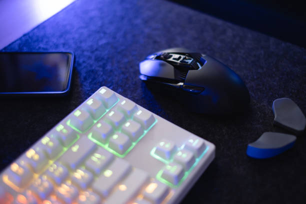 istock gamer work space concept, top view a gaming gear, mouse, keyboard, joystick, headset, mobile joystick, in ear headphone and mouse pad on black table background. 1323331517