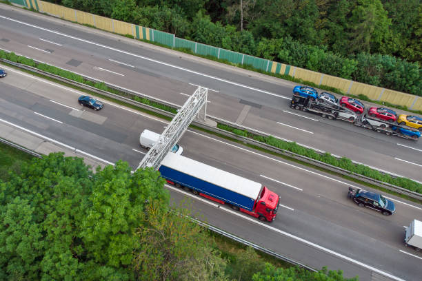 istock Truck toll system on highway - control gantry, aerial view 1323332657