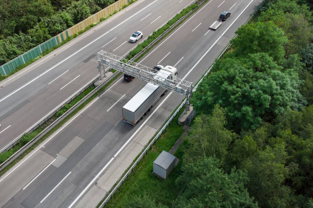 istock Truck toll system on highway - control gantry, aerial view 1323332671