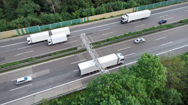 istock Truck toll system on highway - control gantry, aerial view 1323332681