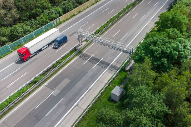 istock Truck toll system on highway - control gantry, aerial view 1323332724