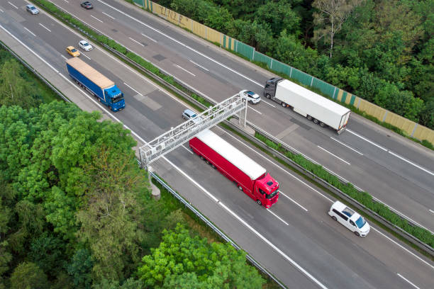 istock Truck toll system on highway - control gantry, aerial view 1323332736