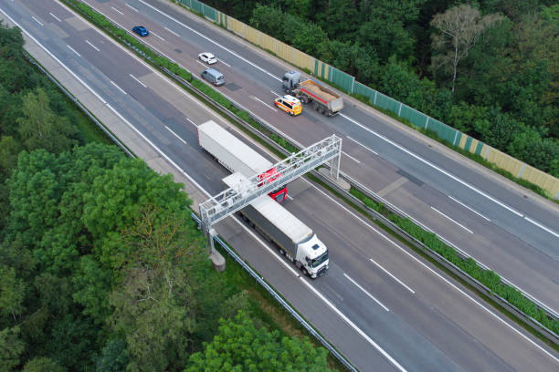 istock Truck toll system on highway - control gantry, aerial view 1323332773