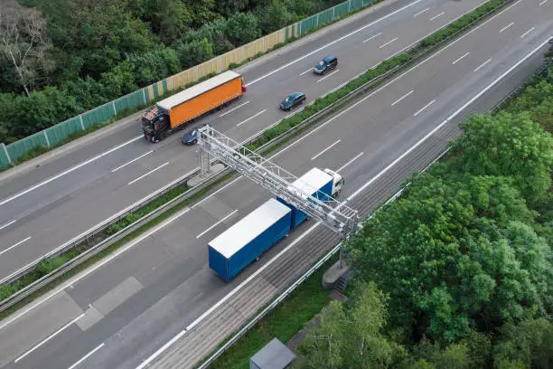 Truck toll system on highway - control gantry, aerial view. TollCollect