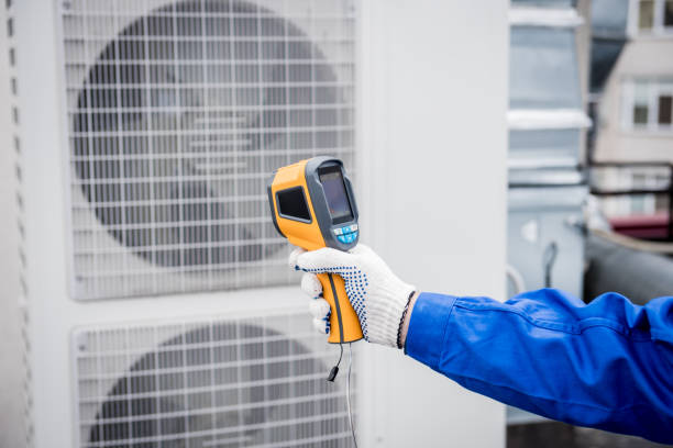 istock Technician uses a thermal imaging infrared thermometer to check the condensing unit heat exchanger. 1323334333