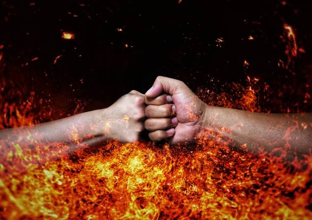 istock Collision fist and flame background 1323339940