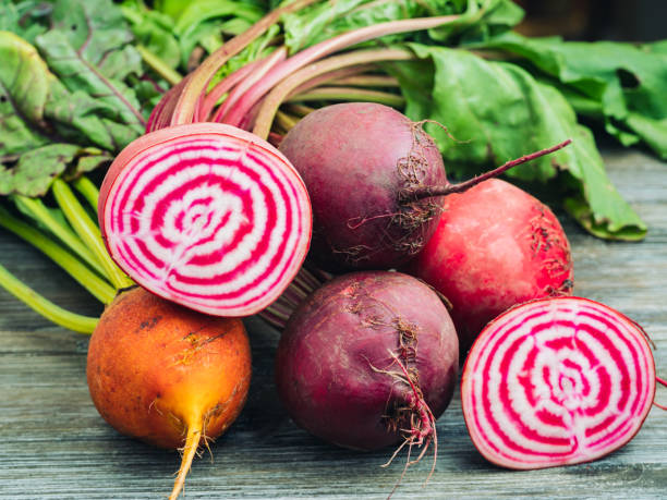 Beet harvest Bunch of fresh organic beet roots on a wooden table. beet stock pictures, royalty-free photos & images
