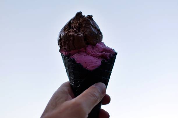 istock chocolate and cherry ice cream in waffle cup 1323341164