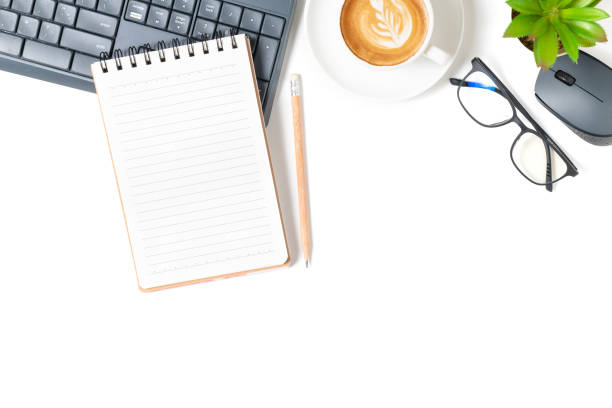 istock White office desk table, Blank notebook with laptop and hot coffee. 1323342598