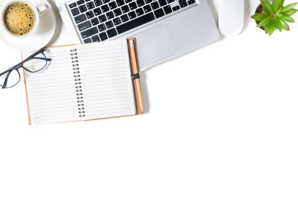 istock White office desk table, Blank notebook with laptop and black coffee. 1323342624