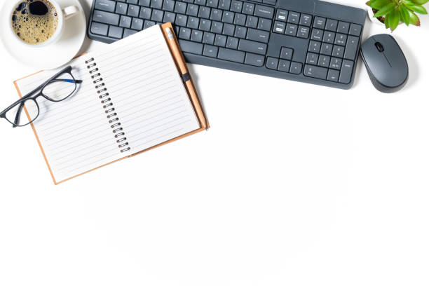 istock White office desk table, Blank notebook with laptop and black coffee isolated 1323342654