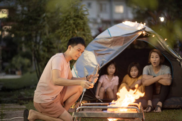 istock Asian Chinese father  setting up fire camping using spirit at backyard 1323343956