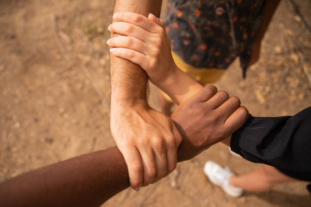 Three hands of different ethnicities grasp each other and form a triangle. Diversity concept Three hands of different ethnicities grasp each other and form a triangle. Diversity concept. racial equality photos stock pictures, royalty-free photos & images
