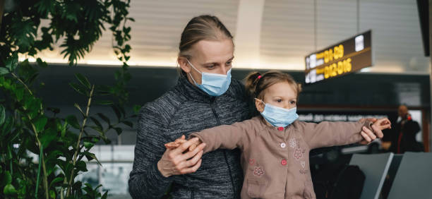 istock Father and child looking though lounge window at airport 1323347812