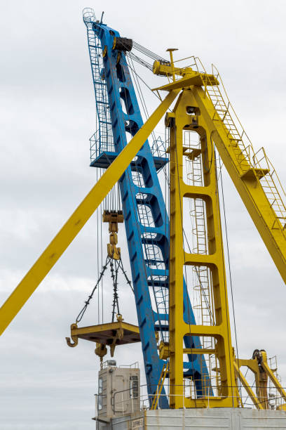 istock Large cranes in the river port. Outdoors, day light Front view 1323349143