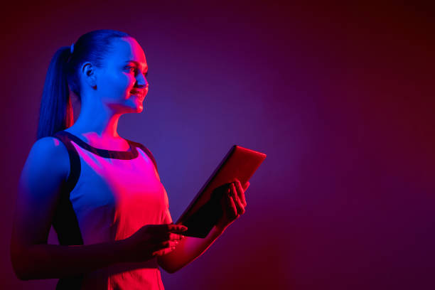 istock digital future cyber technology neon woman tablet 1323350058