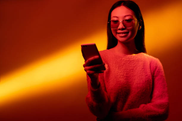 istock digital people mobile technology neon girl phone 1323350081