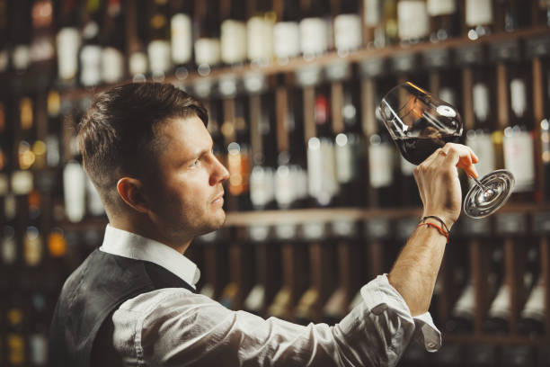 istock Male sommelier tasting red wine at cellar. 1323350750