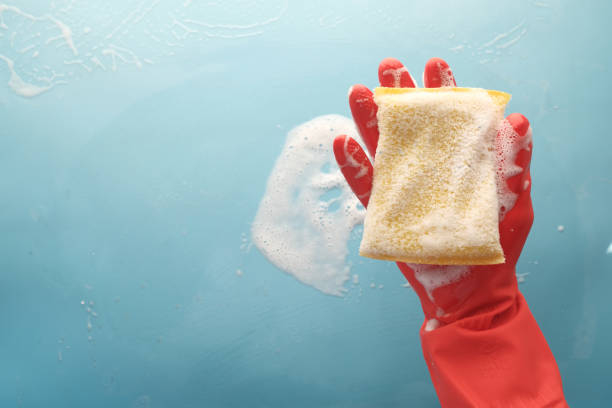 istock hand with rubber gloves holding sponge 1323350822