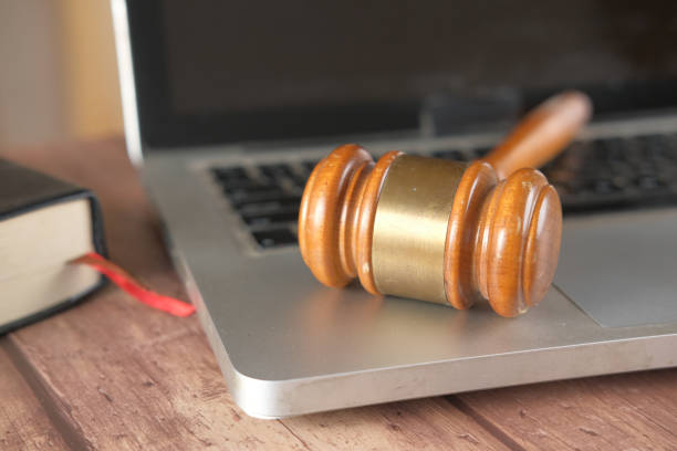 istock close up of a gavel on laptop on table 1323350913