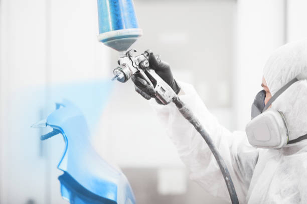 istock Man sprays blue dye on the elements of the vehicle. 1323351789