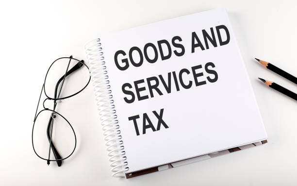 istock Notepad with text GST as Goods and Services Tax . White background. Business concept 1323355761