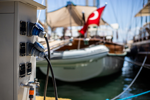 Mooring rope with a knot. Luxury yacht moored with a white rope to the pier in the marina