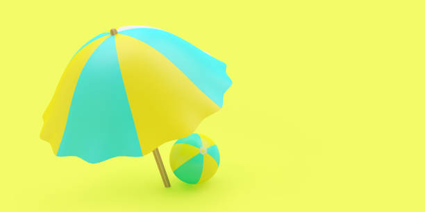 istock Beach umbrella with beach ball on yellow 1323358107