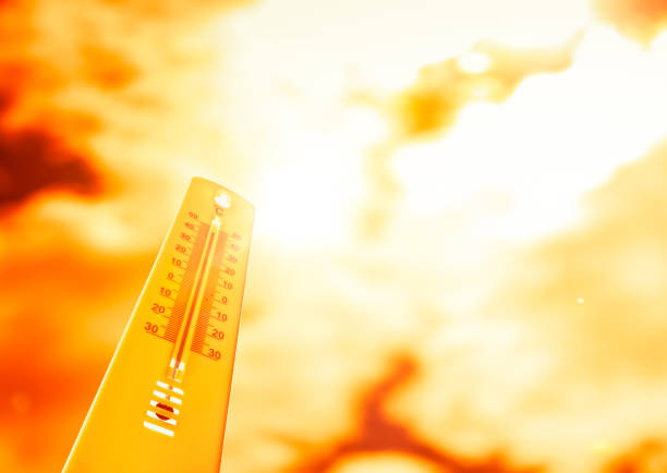 Thermometer at hot temperatures in front of the background