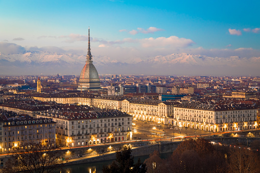 Turin, Piedmont Region, Italy. Panorama from Monte dei Cappuccini (Cappuccini's Hill) at sunset with Alps mountains and Mole Antonelliana monument.