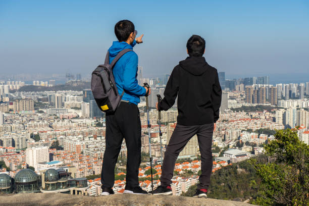 istock Two men look out over the city after climbing high 1323364054
