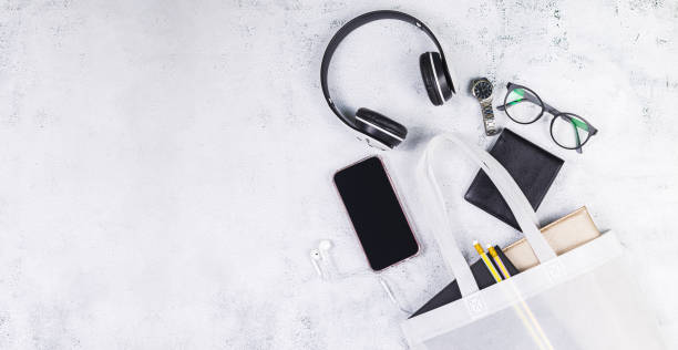 istock White women's leather bag with eyeglasses book and smart watch, phone, earphone, notepad. 1323364691