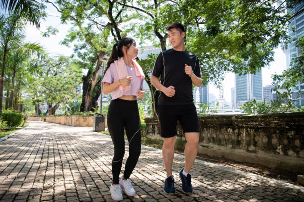 istock Asian couple jogging in the park 1323369006