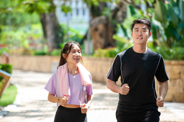 istock Asian couple exercising in the park 1323369042