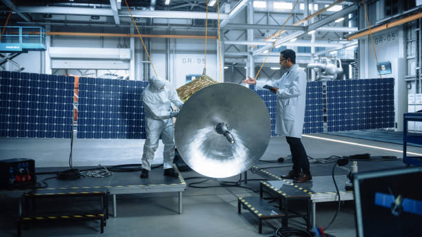 istock Team of Engineers Working on Satellite Construction. Aerospace Agency: Diverse Group of Scientists Developing Spacecraft for Space Exploration, Navigation, Communications, Galaxy Observation 1323369462