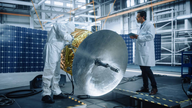 istock Engineer and Technician Working on Satellite Construction. Aerospace Agency: Diverse Team of Scientists Using Technological Equipment and Tablet Computer to Develop Spacecraft for Space Exploration 1323369466