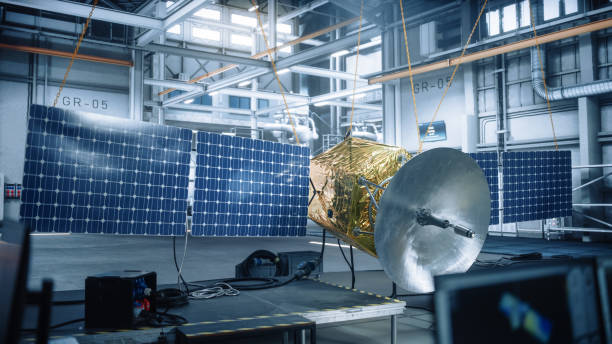 istock Satellite Under Construction in Aerospace Technology Manufacturing Facility. Development of Spacecraft for Space Exploration, Navigation, Communications, Internet Telecommunication, Observation 1323369490