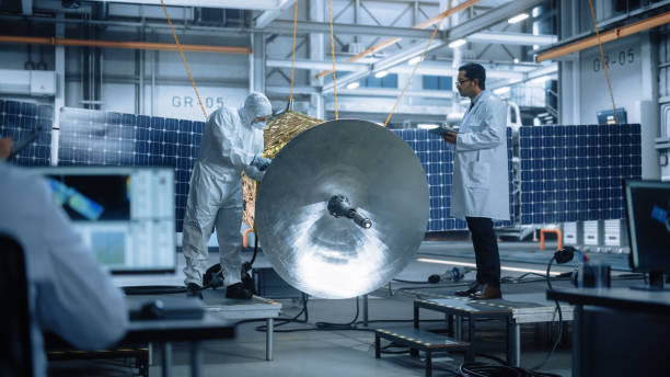 istock Engineer and Technician Working on Satellite Construction. Aerospace Agency: Diverse Team of Scientists Using Technological Equipment and Tablet Computer to Develop Spacecraft for Space Exploration 1323369492