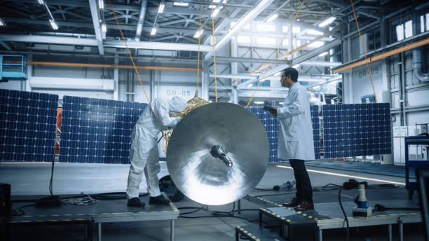istock Team of Engineers Working on Satellite Construction. Aerospace Agency Spaceship Manufacturing Factory: Diverse Group of Scientists Developing Spacecraft for Global Space Exploration Program 1323369500