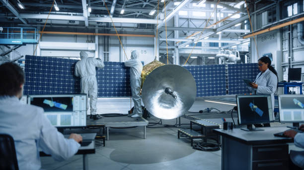 istock Team of Engineers Working on Satellite Construction. Aerospace Agency: Diverse Group of Scientists Developing Spacecraft for Space Exploration, Navigation, Wireless Communications, Cosmos Observation 1323369505