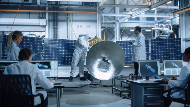 istock Engineer and Technician Working on Satellite Construction. Aerospace Agency: Diverse Team of Scientists Using Technological Equipment and Tablet Computer to Develop Spacecraft for Space Exploration 1323369513