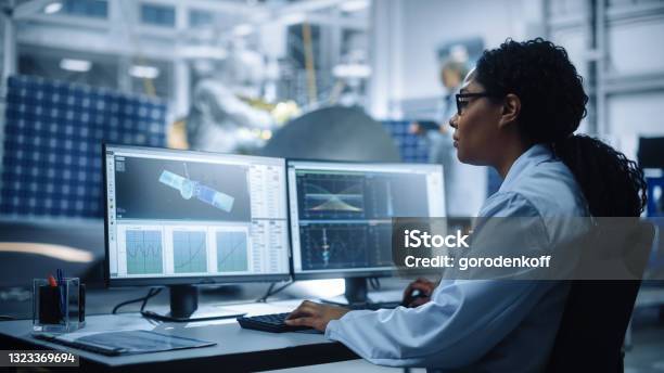 Female Engineer Uses Computer To Analyse Satellite Calculate Orbital Trajectory Tracking Aerospace Agency International Space Mission Scientists Working On Spacecraft Construction Over Shoulder Stock Photo - Download Image Now