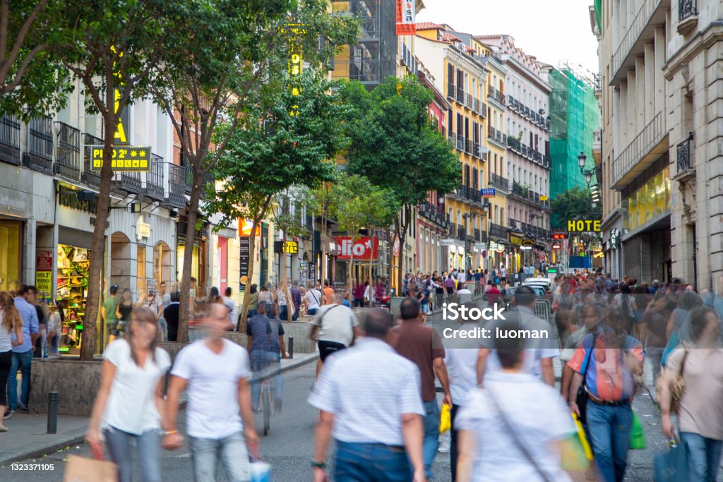 Madrid Large group of people walking along pedestrian street with shops. Madrid Stock Photo