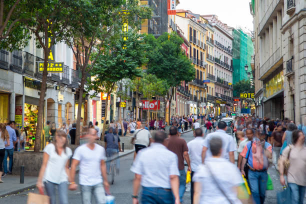 Madrid Large group of people walking along pedestrian street with shops. madrid photos stock pictures, royalty-free photos & images