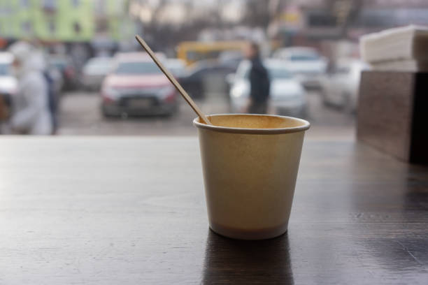 istock used disposable paper cup with a wooden stick stands 1323373057