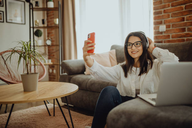 istock A young female student sitting on thek couch using laptop headphones when studying 1323374407