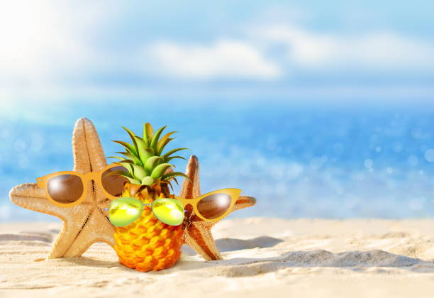 istock Pineapple and starfish with sunglasses in the beach. Summer concept. 1323374581