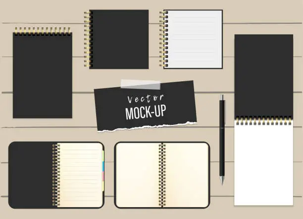 Vector illustration of Vector realistic set of open and closed notepads, organizer, diary, a pen on wooden background. Mockup. Stylish black. Different shapes and formats. Blank templates for branding, corporate style. EPS10